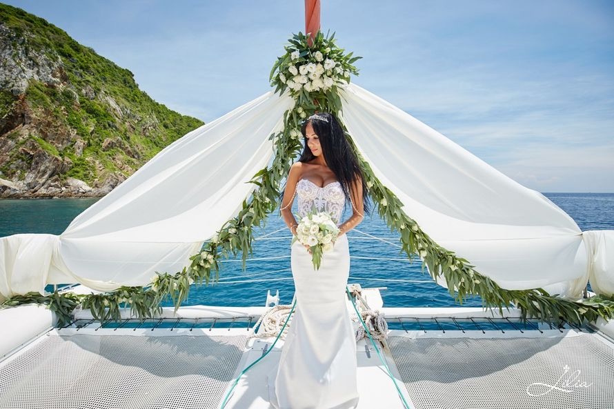 floral and satin arch in a catamaran wedding