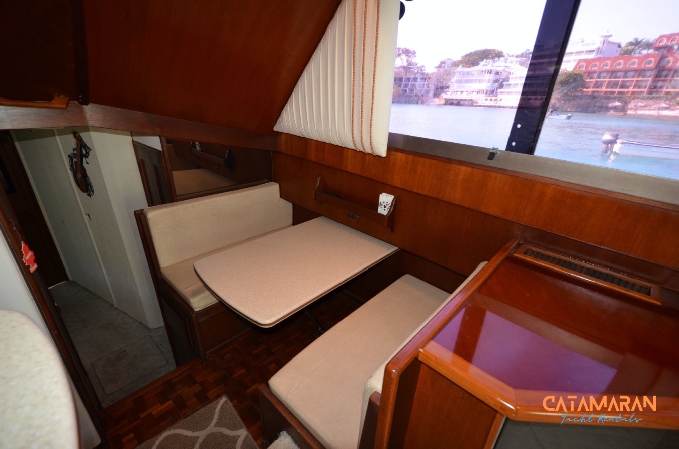 A dinette with seating, in the yacht salon.